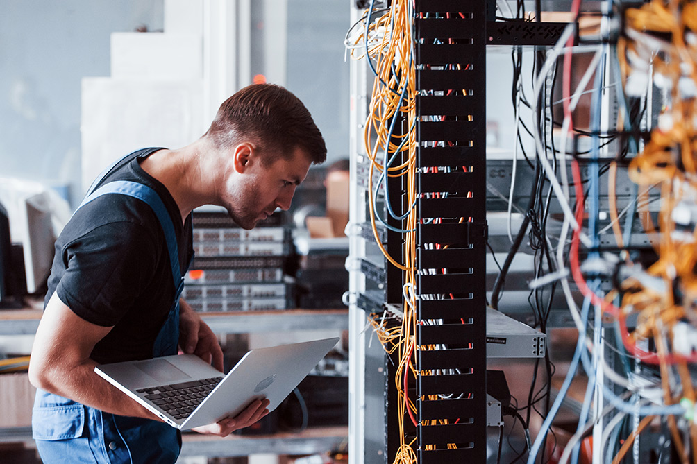 Fibre optic specialist running tests in data centre